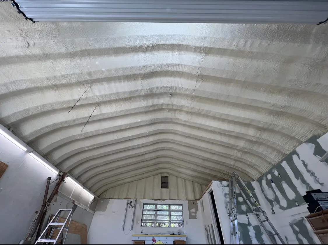 Spray polyurethane foam applied to the underside of a metal roof deck in Acton